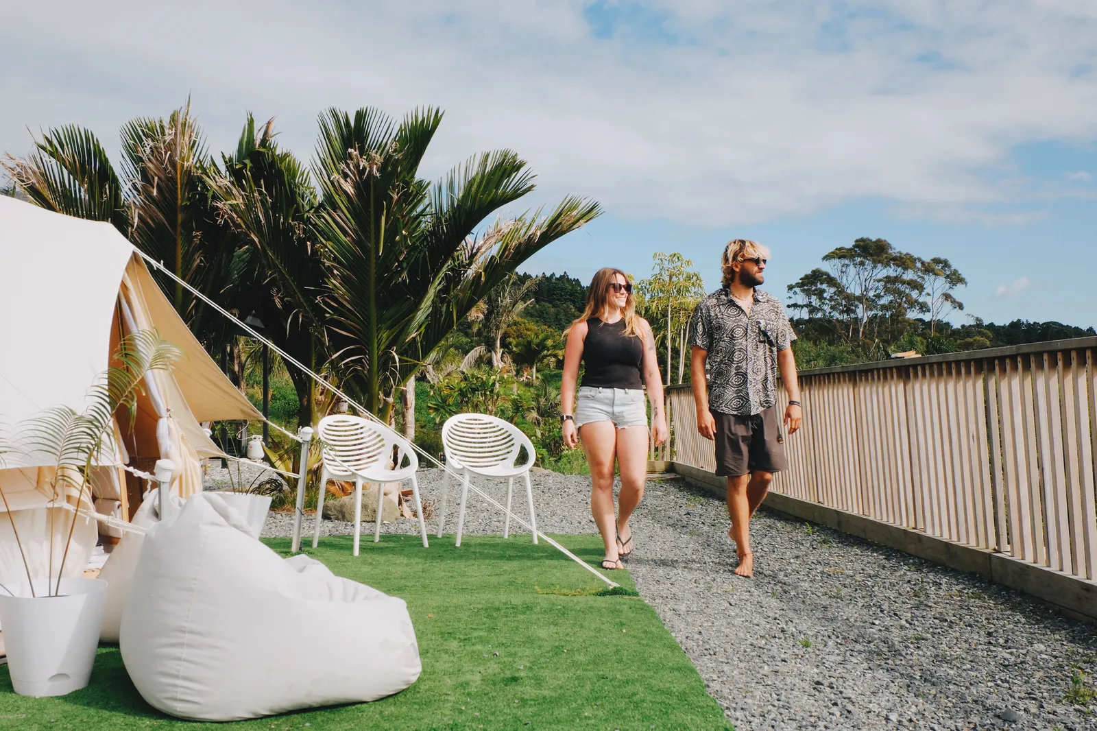Couple walking to their glamping teepee