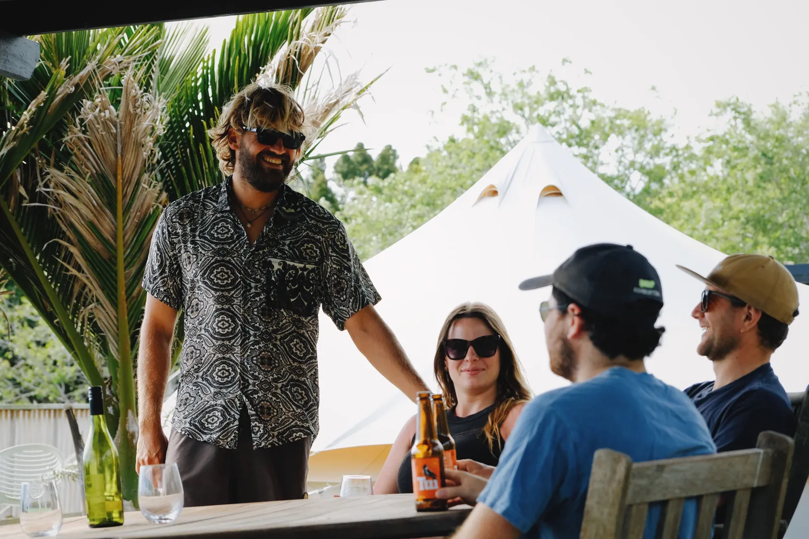 Crew relaxing at the glamping tables after a surf