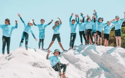 Ultimate Surf Camp kids leaping off the dunes